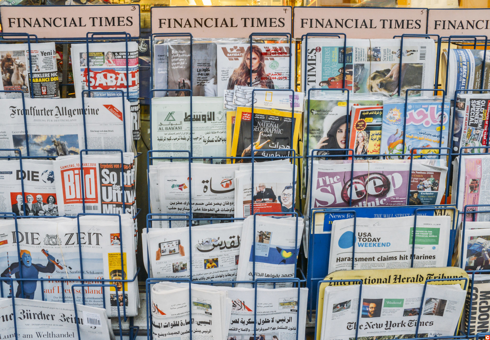 Close up of British and international magazines and newspapers, including Arabic, for sale at a London newstand